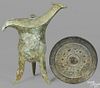 Chinese bronze mirror, 6'' dia., together with an archaic tripod wine vessel or Jue, 10'' h.