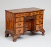 GEORGE I STYLE WALNUT ARCHITECTURAL-FORMED KNEEHOLE DESK, 19TH CENTURY