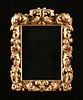A GERMAN BAROQUE STYLE PARCEL GILT CARVED WOOD MIRROR, 19TH CENTURY, 