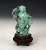 Fairy figure with basket. China, 20th century.
Turquoise carved by hand on wooden base.