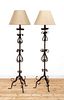 A pair of wrought iron standard lamps,