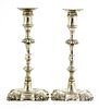 A pair of cast silver table candlesticks,