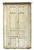 A large George III painted pine corner cupboard,