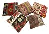 A group of five kilim-covered cushions,