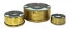 A set of three graduated brass-bound magic lantern condenser lenses,