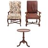 2 sillones y mesa auxiliar. SXX. Elaborados en madera. Un sillón con tapicería de piel color marrón y otro de tela.