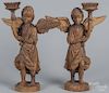 Pair of carved walnut figural pricket sticks, early 20th c., 16'' h.