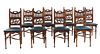 A set of eight Arts and Crafts oak dining chairs,