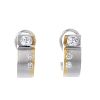 A pair of 18ct gold diamond ear hoops. Each of bi-colour design, comprising a tension-set brilliant-