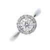 A diamond cluster ring. The illusion-set brilliant-cut diamond, within a similarly-cut diamond halo,