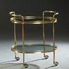 French Brass and Glass Dessert Cart, 20th c., the oval smoked glass shelf within a pierced brass gallery, to a like lower shelf with three brass bottl
