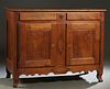 French Provincial Louis XV Style Carved Cherry Sideboard, early 19th c., the three board top over two frieze drawers above double cupboard doors with 