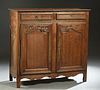 French Provincial Louis XV Style Carved Oak Sideboard, 19th c., the stepped rounded corner top over two frieze drawers, above double fielded panel cup