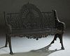 Ornate Reticulated Cast Iron Bench, 20th/21st c., the center fan back with a shell and scroll crest over a pierced trefoil emanating rays, flanked by 