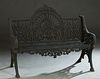Ornate Reticulated Cast Iron Bench, 20th/21st c., the center fan back with a shell and scroll crest over a pierced trefoil eminating rays, flanked by 