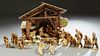 Thirty Piece Carved Wood Anri Nativity Set, 20th c., consisting of a large lighted manger with a windup music box, 2 Virgin Mary figures, 2 Joseph Fig