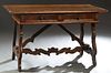 French Provincial Carved Oak Writing Table, 19th c., the rounded edge top over two frieze drawers, on cabriole leg open trestle bases joined by serpen