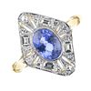 A sapphire and diamond cluster ring. The oval-shape sapphire collet, within an openwork single and b