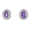 A pair of 9ct gold amethyst and diamond cluster ear studs. Each designed as an oval-shape amethyst,