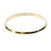 A 22ct gold bangle. With faceted chevron design. Hallmarks for London, 2011. Inner diameter 8.5cms.