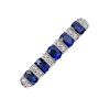 An 18ct gold sapphire and diamond ring. The oval-shape sapphires, with brilliant-cut diamond spacers
