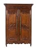 A Louis XV Provincial Brass Mounted Carved Oak Armoire