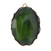 A 9ct gold mounted green hardstone brooch. The oval green hardstone, within a scalloped surround. Ha