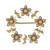 An early 20th century gold split and seed pearl wreath brooch. The split and seed pearl flowers with