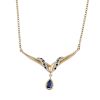 A 9ct gold sapphire necklace. The pear-shape sapphire drop, suspended from a circular-shape sapphire