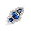 An 9ct gold sapphire and diamond dress ring. The oval-shape sapphire and pear-shape sapphire sides,