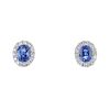 * A pair of sapphire and diamond cluster ear studs. Each designed as an oval-shape sapphire, within