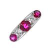A mid 20th century 18ct gold synthetic ruby and diamond five-stone ring. The circular-shape rubies,