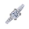 An 18ct gold moissanite single-stone ring. The circular-shape moissonite, to the pave-set similarly-