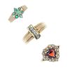 A selection of three 9ct gold gem-set rings. To include a circular-shape emerald cluster ring, a hea