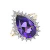 A 9ct gold amethyst and diamond cluster ring. The pear-shape amethyst, within an illusion-set diamon