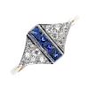 A sapphire and diamond dress ring. The square-shape sapphire line, within a channel setting, to the