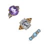 A selection of three 9ct gold gem-set dress rings. To include an amethyst ring with cubic zirconia t