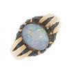 A gentleman's early 20th century 18ct gold opal ring. The oval opal cabochon, within an extended cla