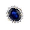 (539806-1-A) A sapphire and diamond cluster ring. The oval-shape sapphire, within a brilliant-cut di