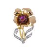 (546082-3-A) A diamond and ruby floral brooch. The circular-shape ruby cluster, within a lobed petal