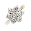 (163989) An 18ct gold diamond cluster ring. Of floral design, the brilliant-cut diamond cluster to t