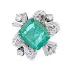 (176761) An emerald and diamond dress ring. Designed as a rectangular-shape emerald within a tapered
