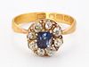 A 22CT GOLD SAPPHIRE AND DIAMOND CLUSTER RING, a cushion-cu