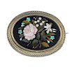 A late Victorian pietra dura brooch. Of oval outline, the hardstone panel depicting a floral spray,