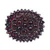 A memorial garnet brooch. Of oval outline, the circular garnets of varying sizes set to a tiered mou