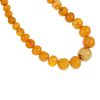 A natural amber bead necklace. Comprising sixty-nine graduated, spherical beads, measuring 0.9 to 2.