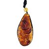 A natural Burmese brown/red amber carved pendant. The pear-shape amber piece, measuring 7.2cms, carv