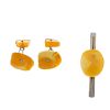 A natural amber tie slide and a pair of cufflinks. The natural amber to the tie slide, of oval outli