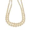 A cultured pearl two row necklace. Comprising two rows of graduated cultured pearls, to the oval gar