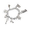 Four charm bracelets. Suspending a total of forty charms, to include a skier within a stein, an elep